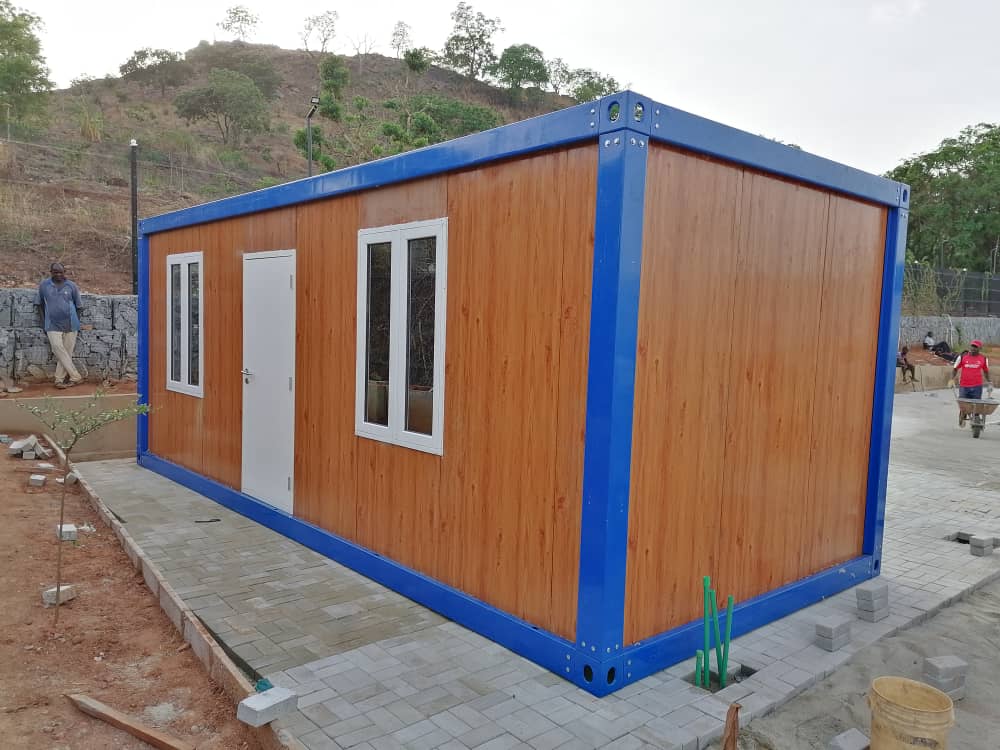 Wood-Finish Site Cabin — Wood-clad cabin on paved site