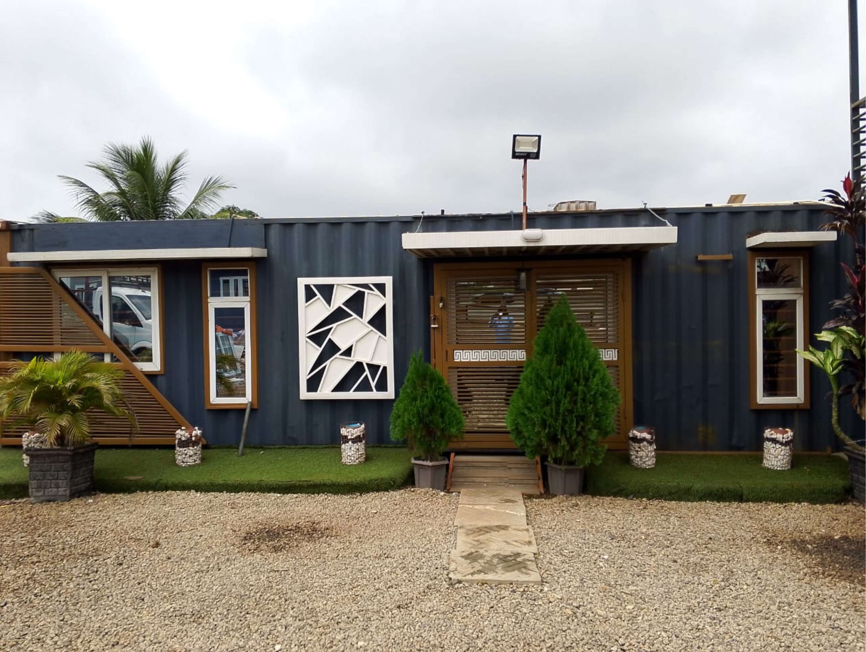 Customised dark blue container lounge with landscaping