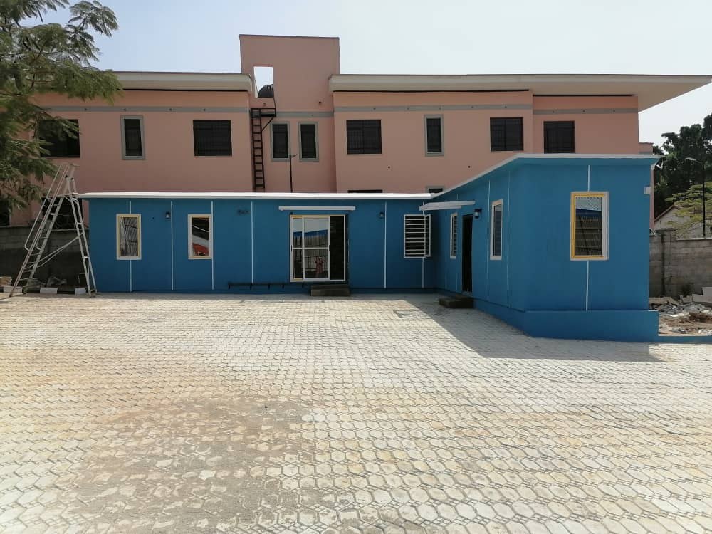 Field Deliveries & Site Installations — Blue annex alongside a permanent building