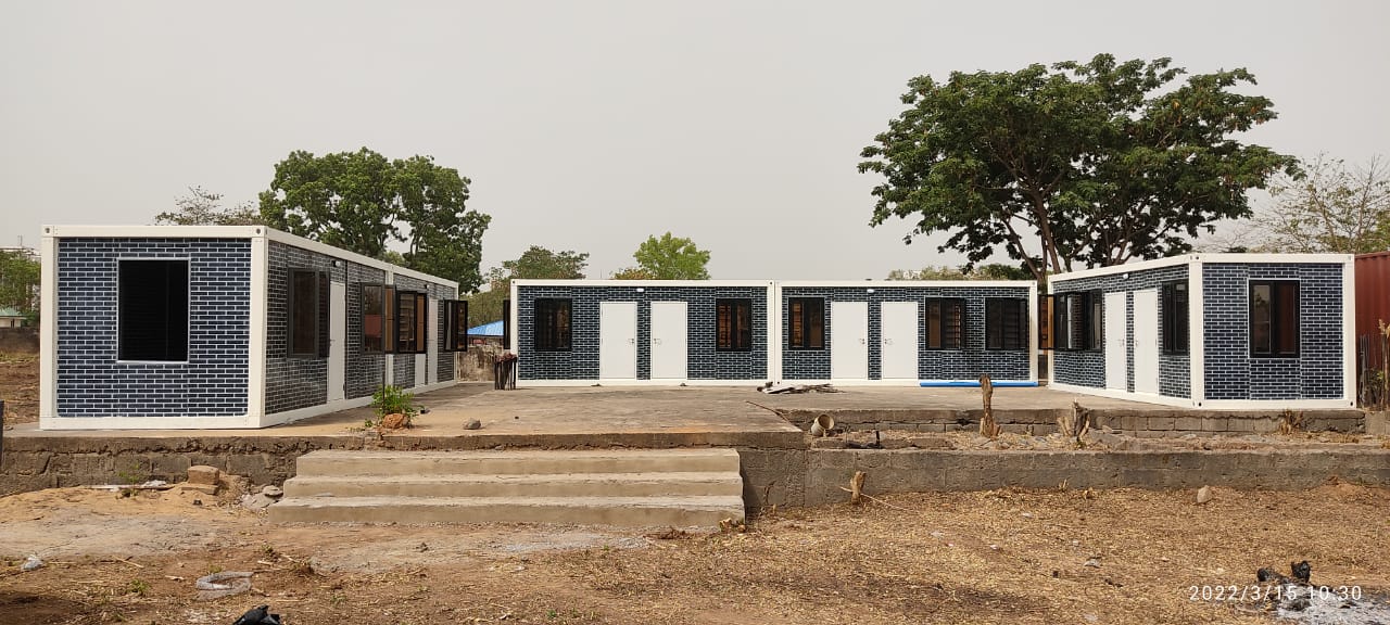 Brick-Clad Modular Camp — Three-block brick-clad camp around concrete forecourt