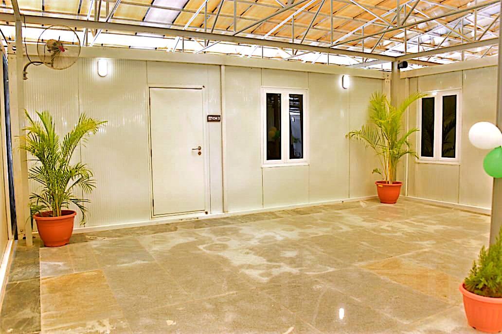 Modular Event Pavilion — Open pavilion floor with planters