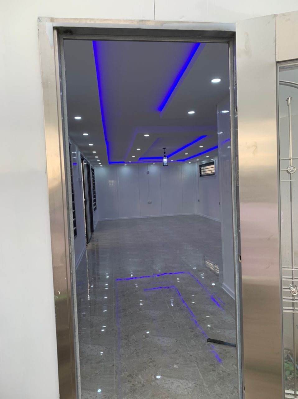 Executive Office Fit-Out — Long interior with blue LED cove lighting