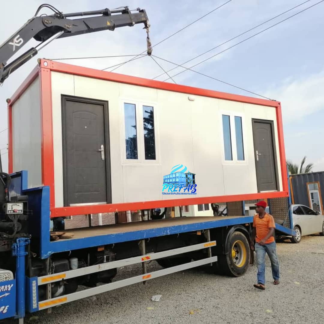 Red-Frame Twin-Door Cabin — Crane offload of red-frame twin-door cabin