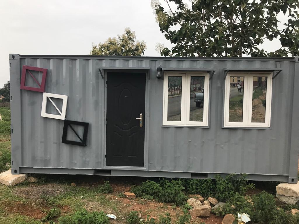 Grey Window-Display Cabin — Grey cabin with window-frame display detail