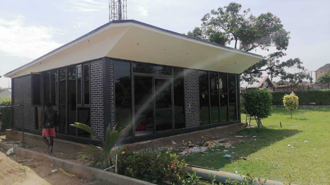 Brick-Clad Glass Pavilion — Pavilion exterior with brick cladding and wrap-around glazing